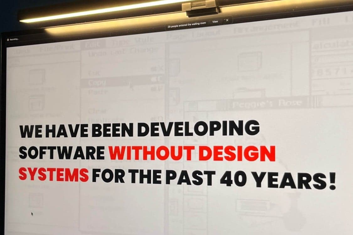 A monitor showing the slide: We have been developing software without design systems for the past 40 years